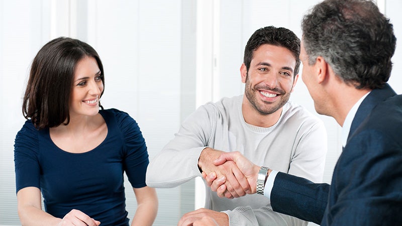 Sales person shaking hands with customer